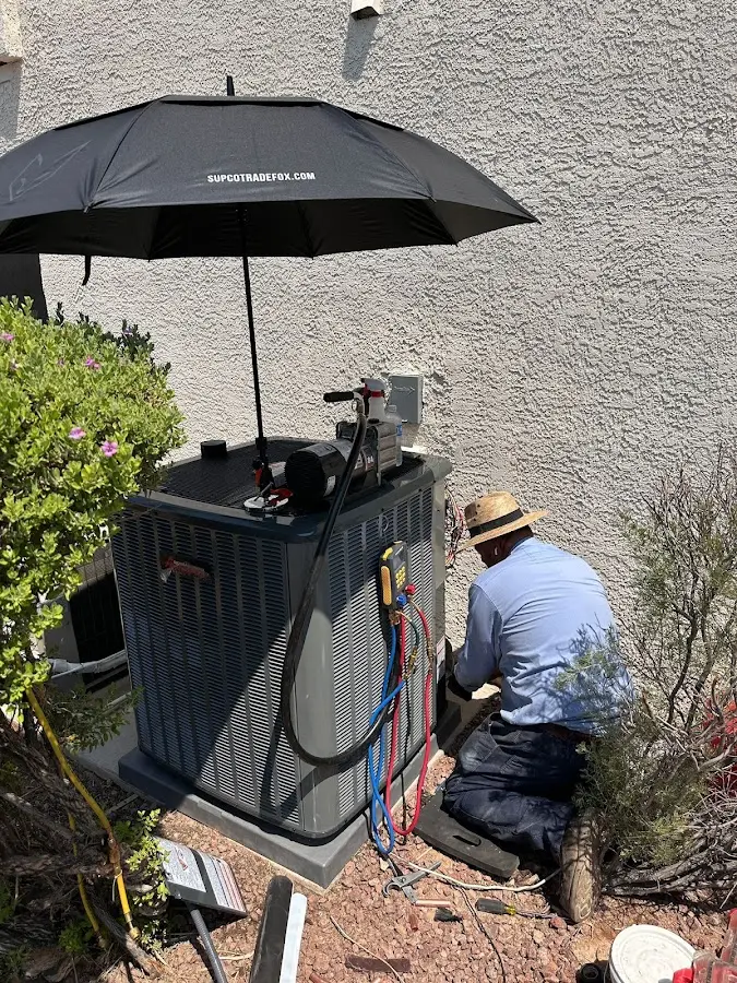 HVAC technician performing outdoor AC maintenance in Old Town